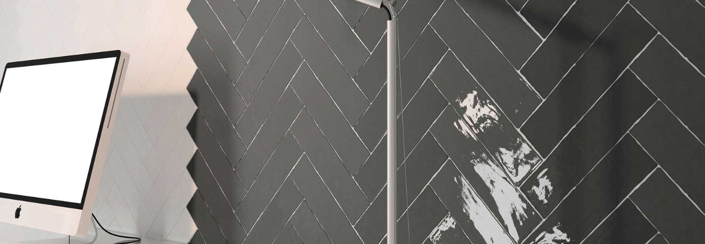 Dark gray and white tile in a herringbone pattern.