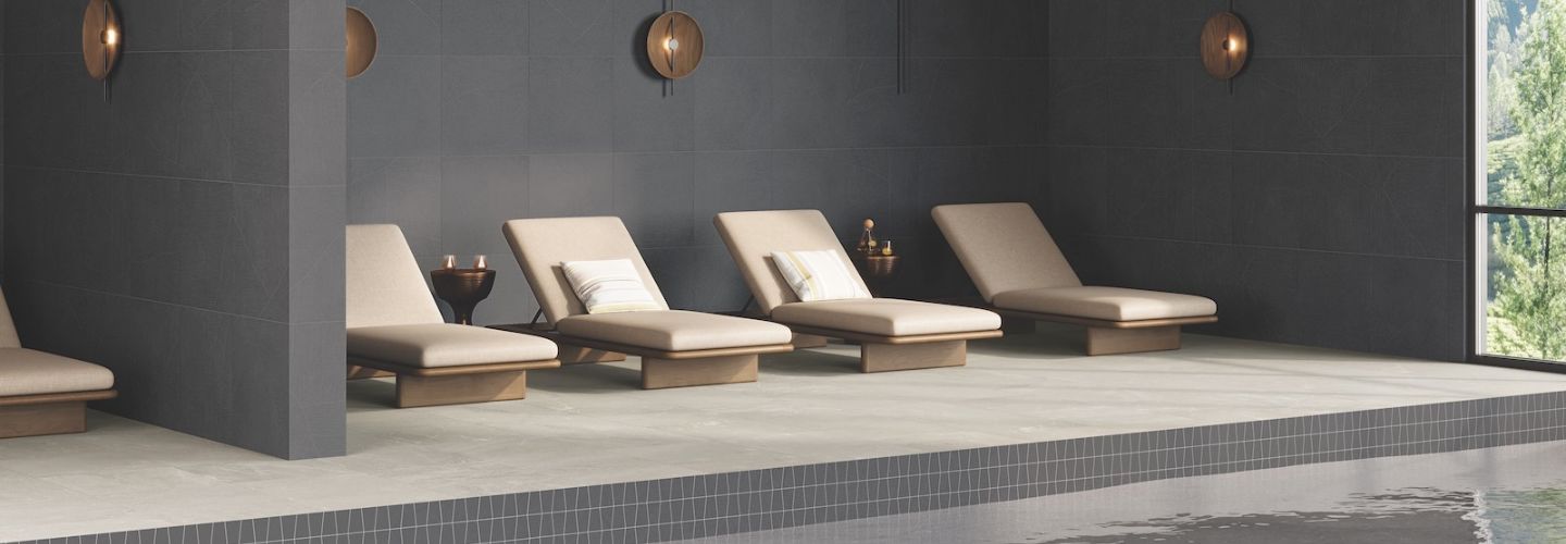 Japandi style pool and spa with Sand Garden porcelain tile on deck and wall, and with trapezoid mosaics on waterline 