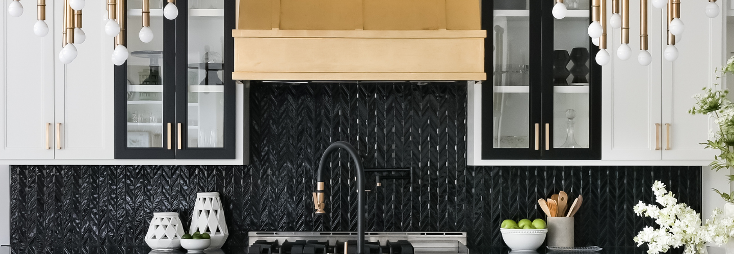 Black, gold white kitchen with glossy, black Crossville Studios chevron tile on blacksplash