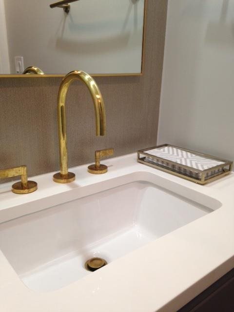 tan backsplash with white countertop bathroom